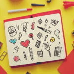 Open bullet journal displaying various header styles from minimalist to decorative with essential tools