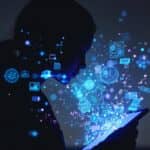 A person's silhouette illuminated by digital patterns from a tablet screen, with floating emotional data visualizations in blue and purple, representing AI journaling technology in a reflective atmosphere.